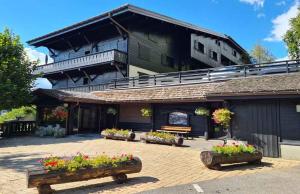 a building with flowers in front of it at Alpenrose Saint Gervais les Bains in Saint-Gervais-les-Bains