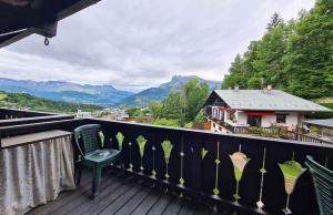 a balcony with a chair and a view of mountains at Alpenrose Saint Gervais les Bains in Saint-Gervais-les-Bains