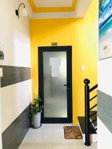 a door in a hallway with yellow walls at Monkeyland Cham island Homestay in Tân Hiệp