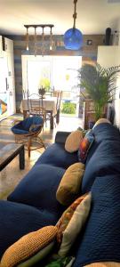 a living room with two blue couches with pillows at La Barrosa duplex in Chiclana de la Frontera