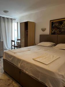 a bedroom with a bed with a towel on it at Apartments Kuljaca in Budva