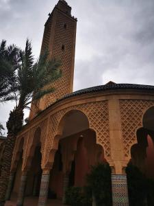 a building with a clock tower on top of it at Riad NEJJARINE in Marrakesh