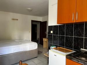 a kitchen with a bed in the middle of a room at Apartments Kuljaca in Budva