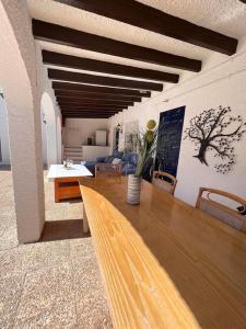 a living room with a wooden table and a couch at ¡Magnifica Villa Amalia! in Calpe