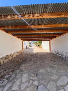 an empty patio with a wooden roof on a building at ¡Magnifica Villa Amalia! in Calpe