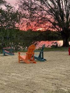a group of chairs sitting in the sand in a park at Waterfront Condo #10 in Punta Gorda