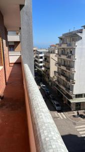 a balcony of a building with a view of a parking lot at Appartamento Nonna Carmela in Pescara