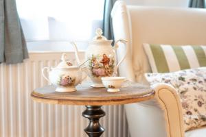 a table with a tea pot and two cups on it at Alpine apartments Marcella in Žirovnica +47 photos