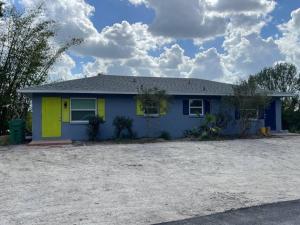 a blue and yellow house with a driveway at Waterfront Condo #7 in Punta Gorda