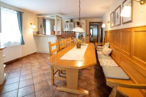 a dining room with a wooden table and chairs at Alpine apartments Marcella in Žirovnica