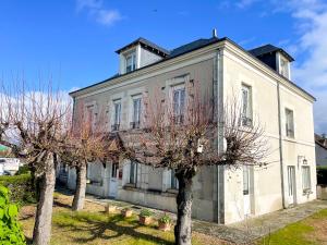 an old house with trees in front of it at Relais Touraine Sologne in Noyers-sur-Cher