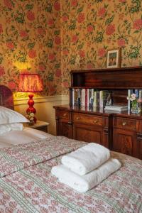 a bedroom with a bed with towels on it at Bell Flat in Broughton Hall in Skipton