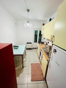 a kitchen with a white refrigerator and a table at CASA BARBARA in Ventimiglia