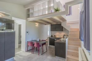 a kitchen with a table and chairs in a room at La terrazza di Marta in Varenna