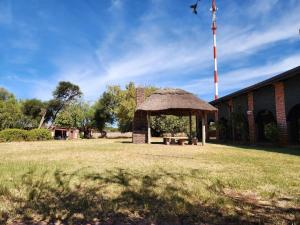 a gazebo with a picnic table in a field at Postmasburg Inn in Postmasburg