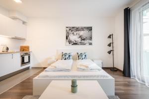 a white apartment with two beds in a room at White Cottage Studio in Budapest
