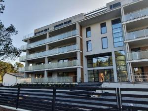an apartment building with stairs in front of it at APARTAMENT NIEBIESKA FALA in Rowy