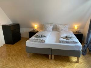 a bedroom with a large bed with two night stands at Ferienhaus am Seedeich in Emden
