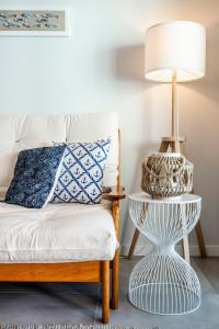 a bedroom with a bed and a lamp on a table at Coastal Holiday´s Apartment in Monte Gordo