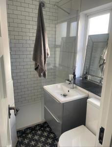 a white bathroom with a sink and a mirror at 4 The Archways in Carrick on Shannon