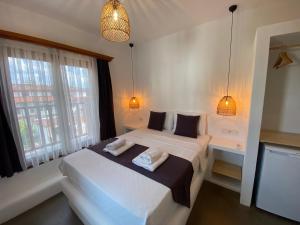 a bedroom with two beds and two windows at Tomsan Suites & Villas Akyaka in Akyaka +128 photos