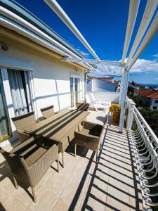 a patio with a table and chairs on a balcony at Apartments Cacija in Trogir
