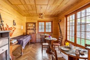 a log cabin dining room with tables and chairs at B&B Chalet Il Picchio in Varzo