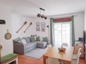 a living room with a couch and a table at Paragem dos Pacatos - Odeceixe in Odeceixe