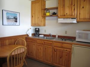 a kitchen with a stove top oven and a microwave at Harrison Street Inn in Cannon Beach