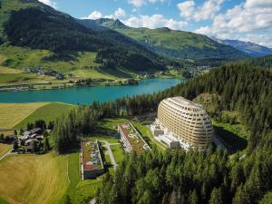 an aerial view of a building next to a lake at AlpenGold Hotel Davos in Davos