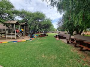 a park with picnic tables and a playground at Pro Plants Accommodation in Kimberley