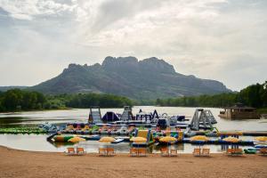 a group of boats on a lake with a mountain at Glamping Côte d'Azur in Roquebrune-sur-Argens