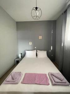 una camera da letto con un grande letto con asciugamani di Seaside Deluxe Apartment a Skala Kallirachis