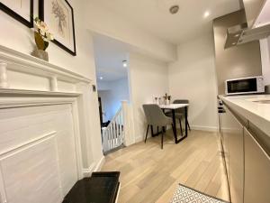 a kitchen and dining room with a table and a counter at Luxeurs - Victoria Street Apartments in Liverpool