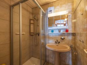 a bathroom with a sink and a shower at Apartment Muverans I L2 by Interhome in Nendaz