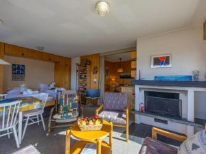 a living room with a couch and a fireplace at Apartment Muverans I L2 by Interhome in Nendaz +27 photos
