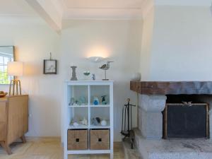 a living room with a white shelf next to a fireplace at Holiday Home Cam Louis by Interhome in Plouescat +36 photos