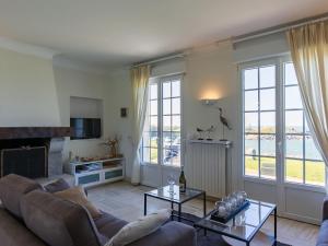 a living room with a couch and a table at Holiday Home Cam Louis by Interhome in Plouescat