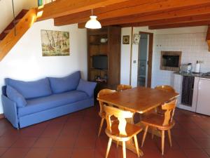 a living room with a blue couch and a table at Holiday Home Le Rose Rosse by Interhome in Grazzano Badoglio