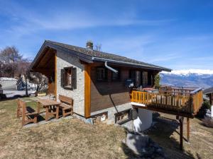 a small cabin with a balcony and a deck at Chalet L'Alouette by Interhome in Nendaz