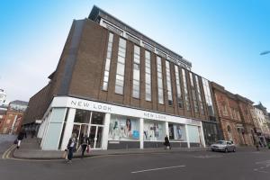 a new look building on the corner of a street at Victoria Centre Apartments in the Victoria Centre Shopping Centre - Nottingham City Centre - 24 hour access - Most Central Location, Kitchen - Sunday check-out 1pm - Opposite Hilton by Restaurants & Shops - Outdoor Parking Cars or Vans five pounds a day in Nottingham