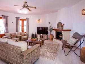 a living room with a couch and a fireplace at Holiday Home Lucia by Interhome in Monte Pego