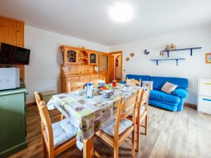 a kitchen and dining room with a table and chairs at Apartment Brunel-1 by Interhome in Pozza di Fassa