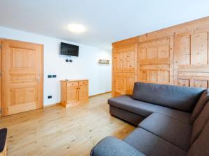 a living room with a couch and wooden floors at Holiday Home Mantel by Interhome in Mazzin