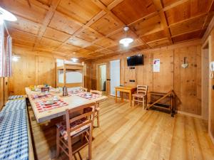 a dining room with a table and chairs in a cabin at Holiday Home Mantel by Interhome in Mazzin