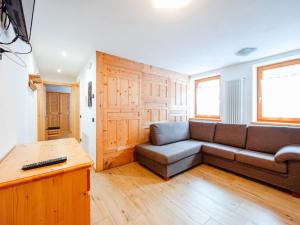 a living room with a couch and a table at Holiday Home Mantel by Interhome in Mazzin +39 photos