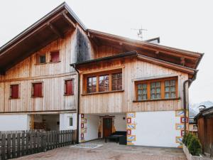 a wooden house with a white garage in front of it at Holiday Home Mantel by Interhome in Mazzin