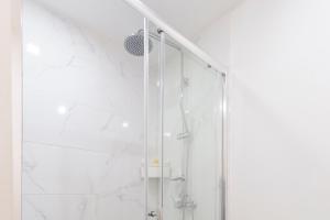 a shower with a glass door in a bathroom at Glória 10 in Lisbon +74 photos