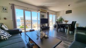 a living room with a couch and a table at Black and White Apartment - 2 bedrooms, walk to the beach in Duće