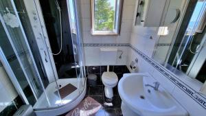 a small bathroom with a sink and a toilet at Black and White Apartment - 2 bedrooms, walk to the beach in Duće +32 photos